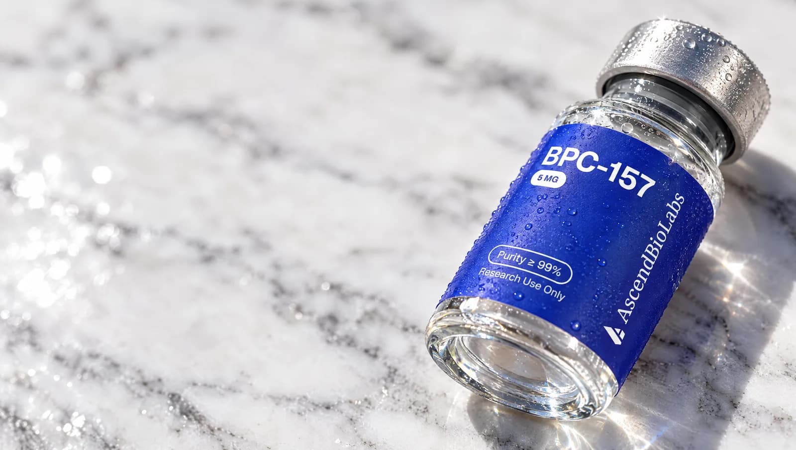 A BPC-157 vial lying on white marble