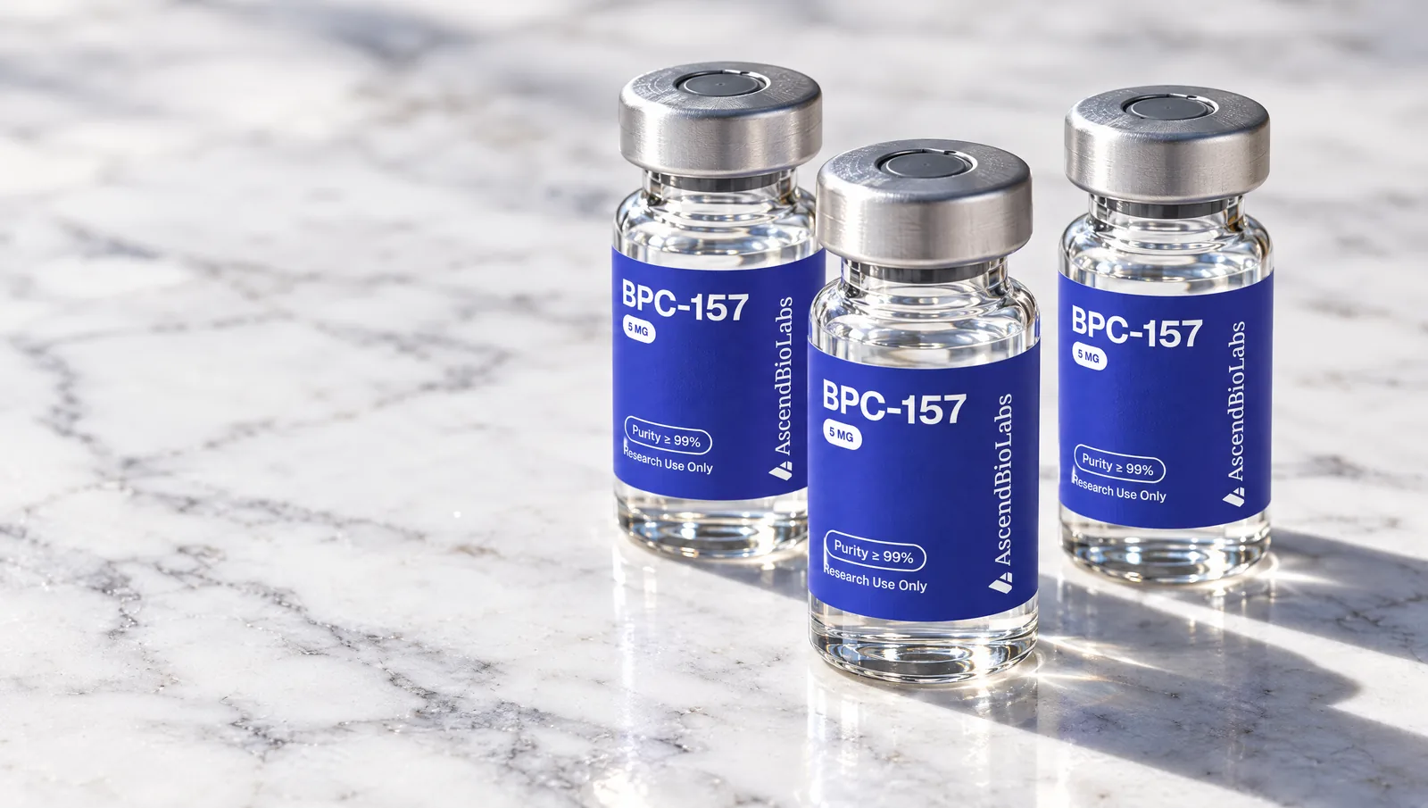 Three BPC-157 vials standing on marble
